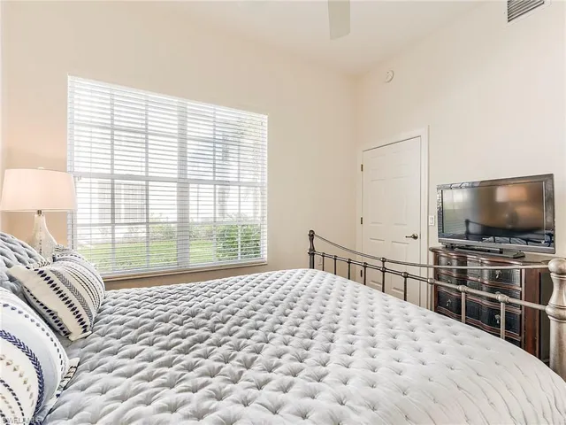 a living room with furniture a lamp and a window