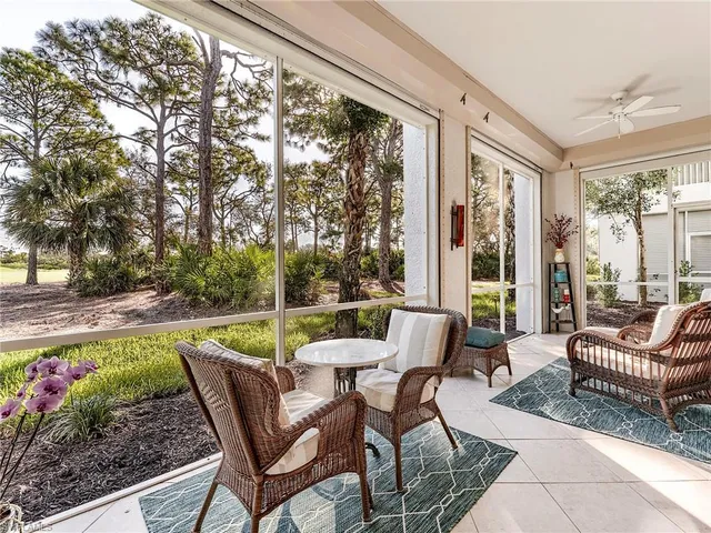 a front view of a house with a garden and trees