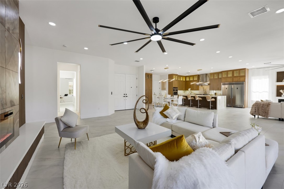 5015 Rivedro Street Las Vegas, NV 89135 - Photo 24 of 91 An open-concept living space with a contemporary design connects seamlessly to a well-appointed kitchen.