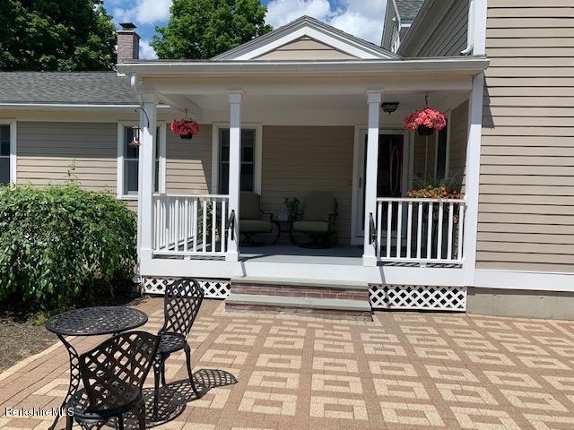 19 State Line Road West Stockbridge, MA 01266 - Photo 33 of 45 a view of a patio with table and chairs with wooden floor and fence