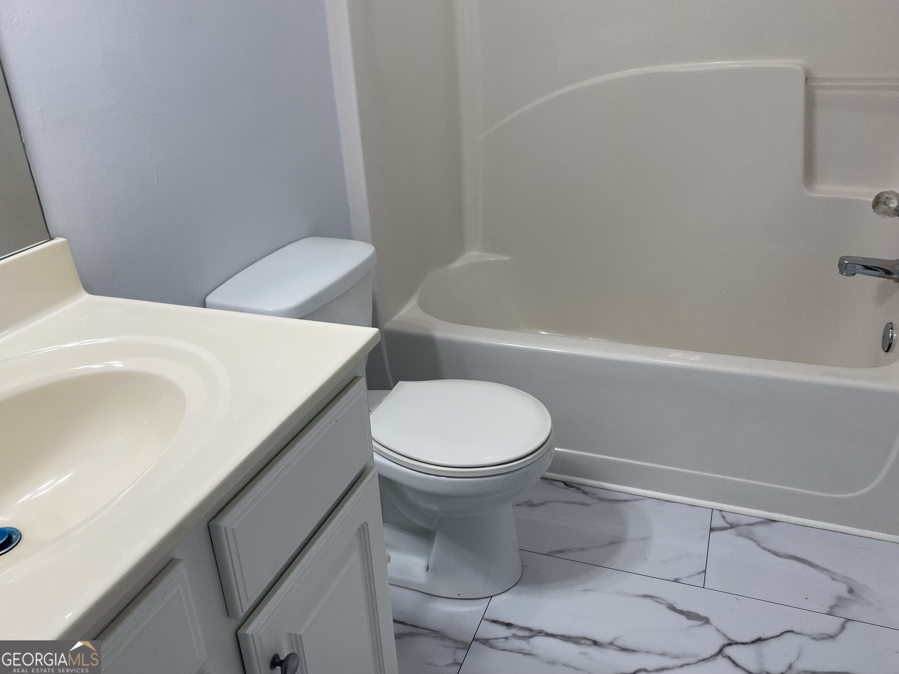 417 Whitehall Road Athens, GA 30605 - Photo 45 of 72 a white toilet and tub sitting next to a bathroom sink