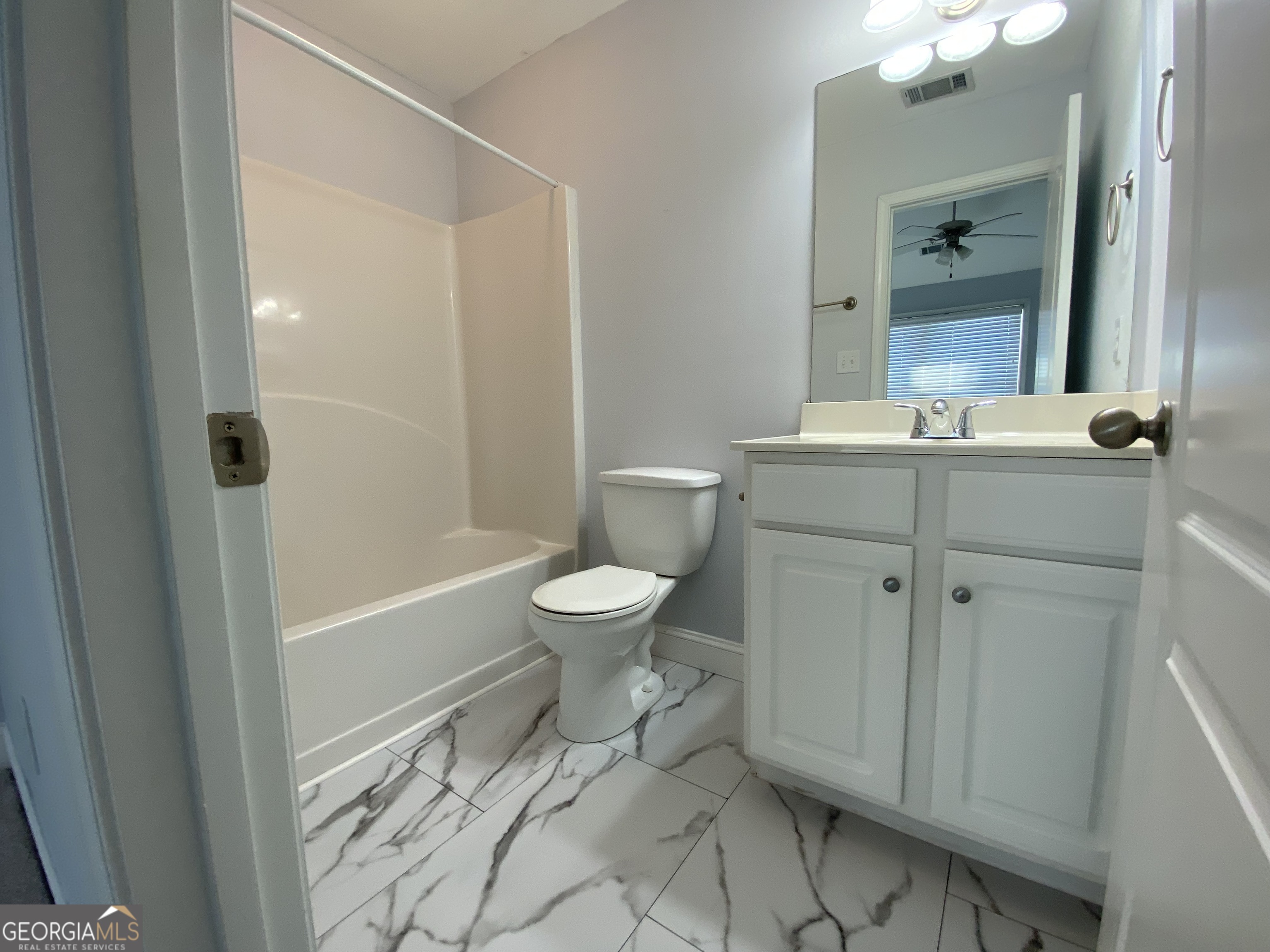 417 Whitehall Road Athens, GA 30605 - Photo 50 of 72 a bathroom with a granite countertop sink toilet a mirror and shower