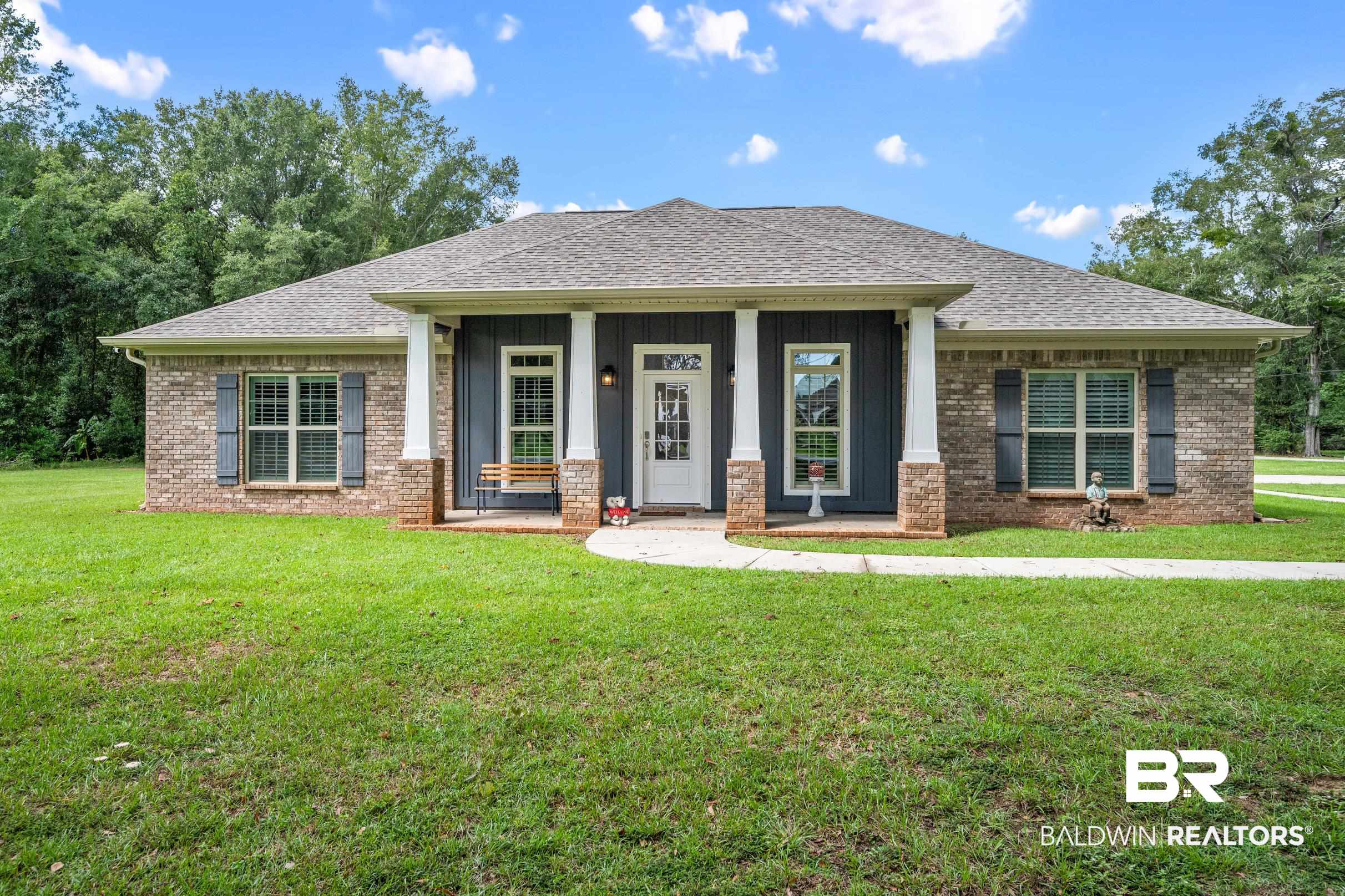1700 South Juniper Street Foley, AL 36535 - Photo 8 of 51 View of front of house featuring a front lawn and covered porch