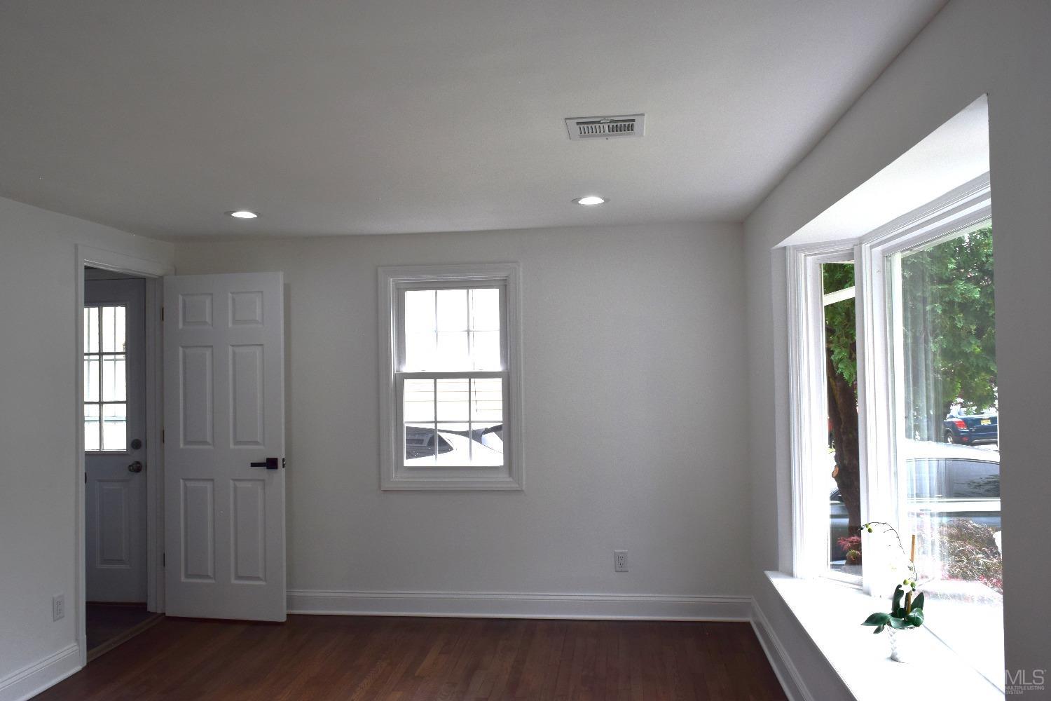 42 West Cliff Road Colonia, NJ 07067 - Photo 2 of 14 an empty room with wooden floor and windows