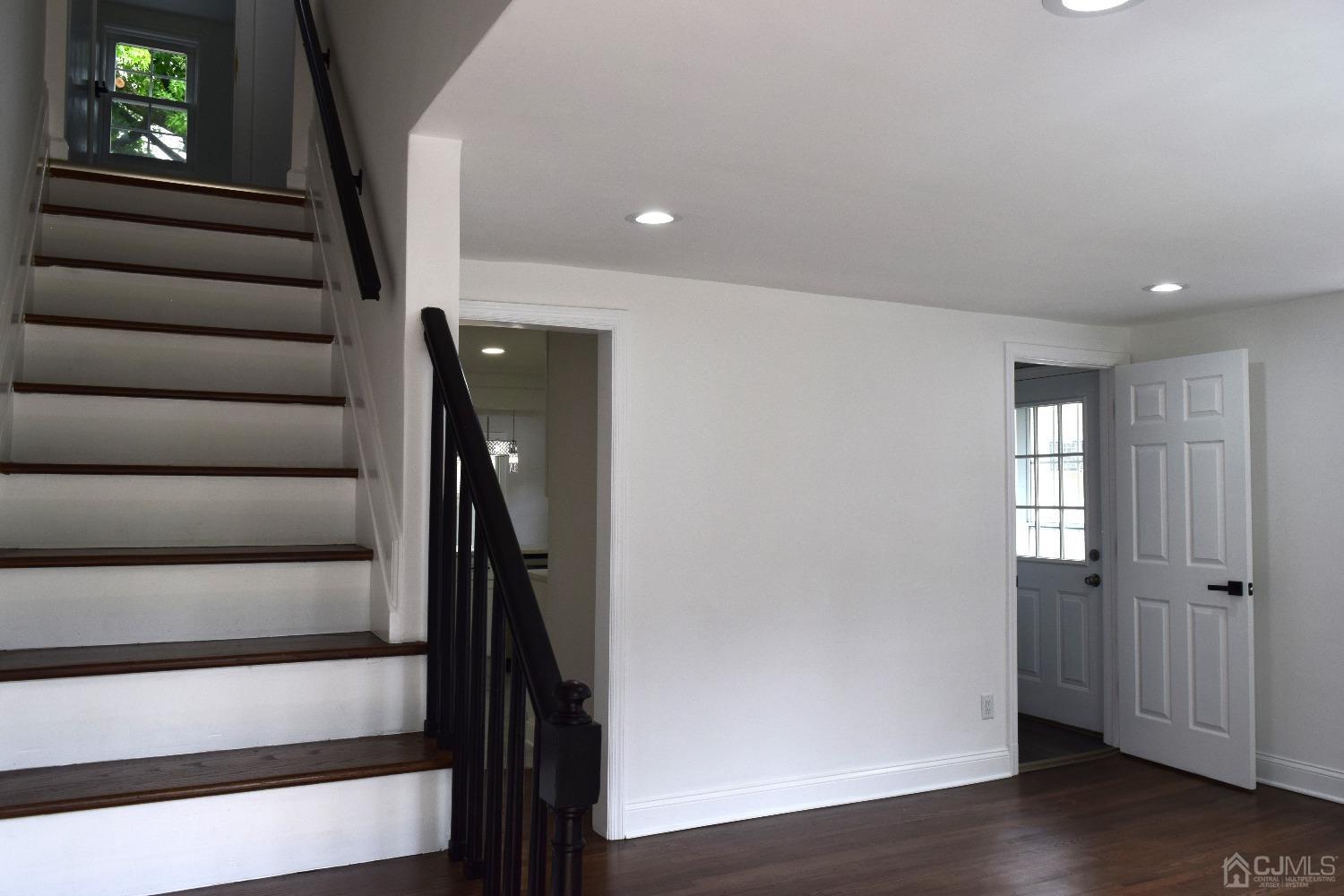 42 West Cliff Road Colonia, NJ 07067 - Photo 3 of 14 a view of entryway with stairs and wooden floor