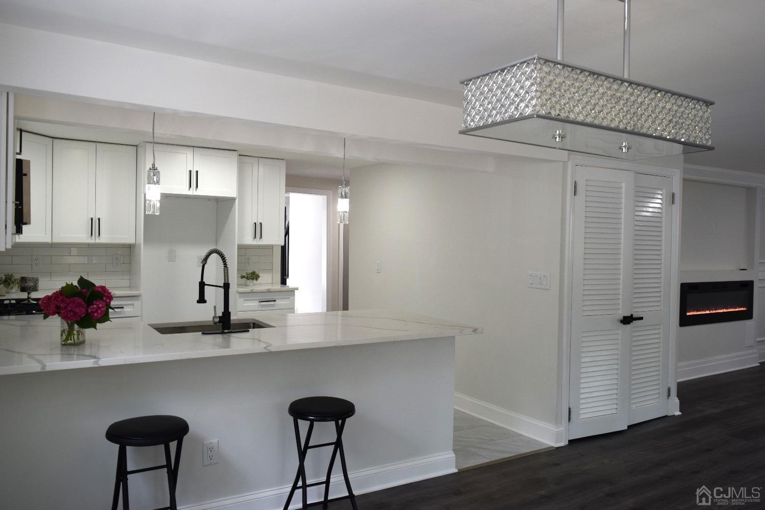 42 West Cliff Road Colonia, NJ 07067 - Photo 6 of 14 a kitchen with cabinets and wooden floor