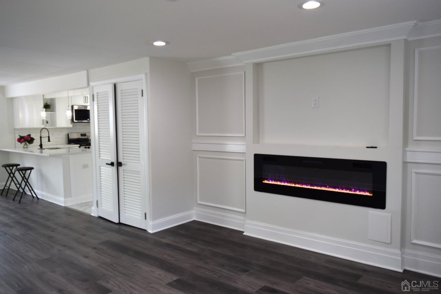 42 West Cliff Road Colonia, NJ 07067 - Photo 8 of 14 a kitchen with wooden floor and a fireplace