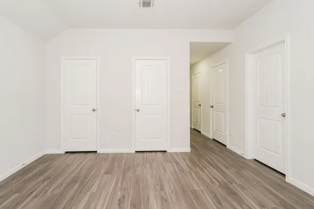an empty room with wooden floor