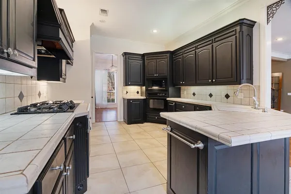 a kitchen with a stove a sink and a refrigerator
