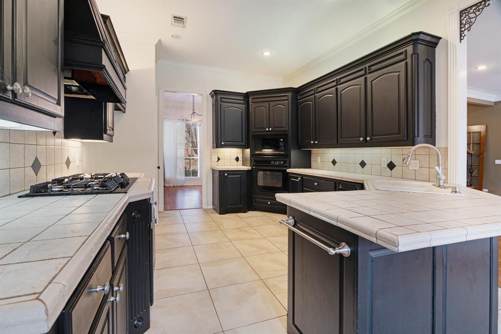 512 Brookes Way Reno, TX 75462 - Photo 11 of 27 a kitchen with a stove a sink and a refrigerator