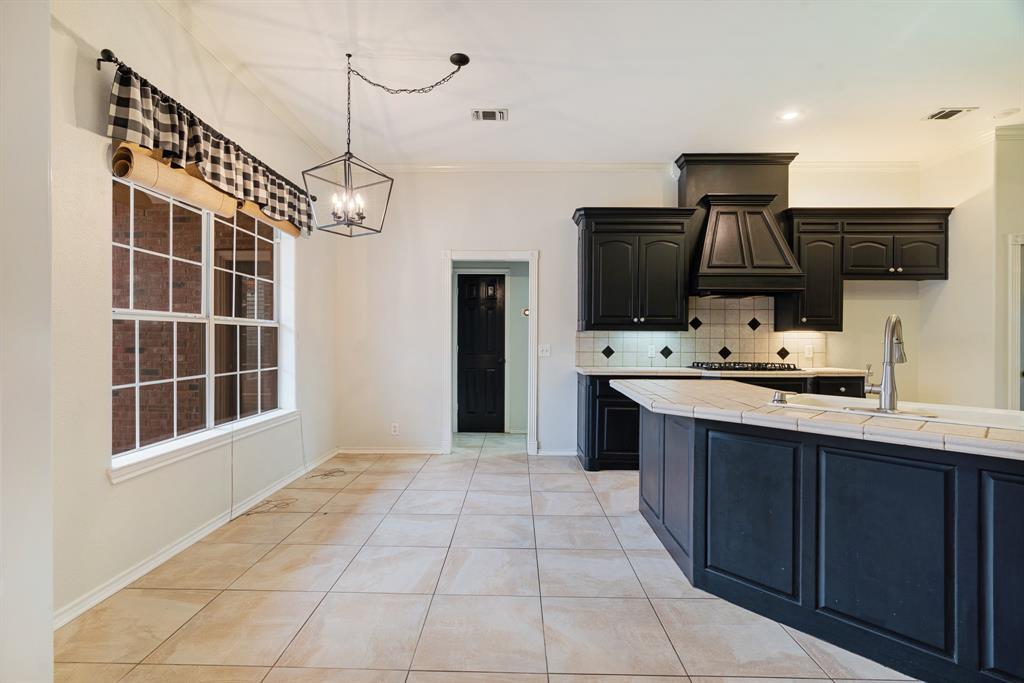 512 Brookes Way Reno, TX 75462 - Photo 12 of 27 a kitchen with stainless steel appliances a stove sink and microwave