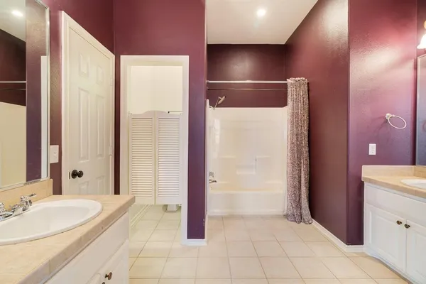 a spacious bathroom with a mirror a bathtub and shower