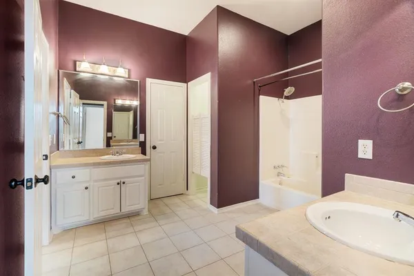 a spacious bathroom with a sink double vanity and a mirror