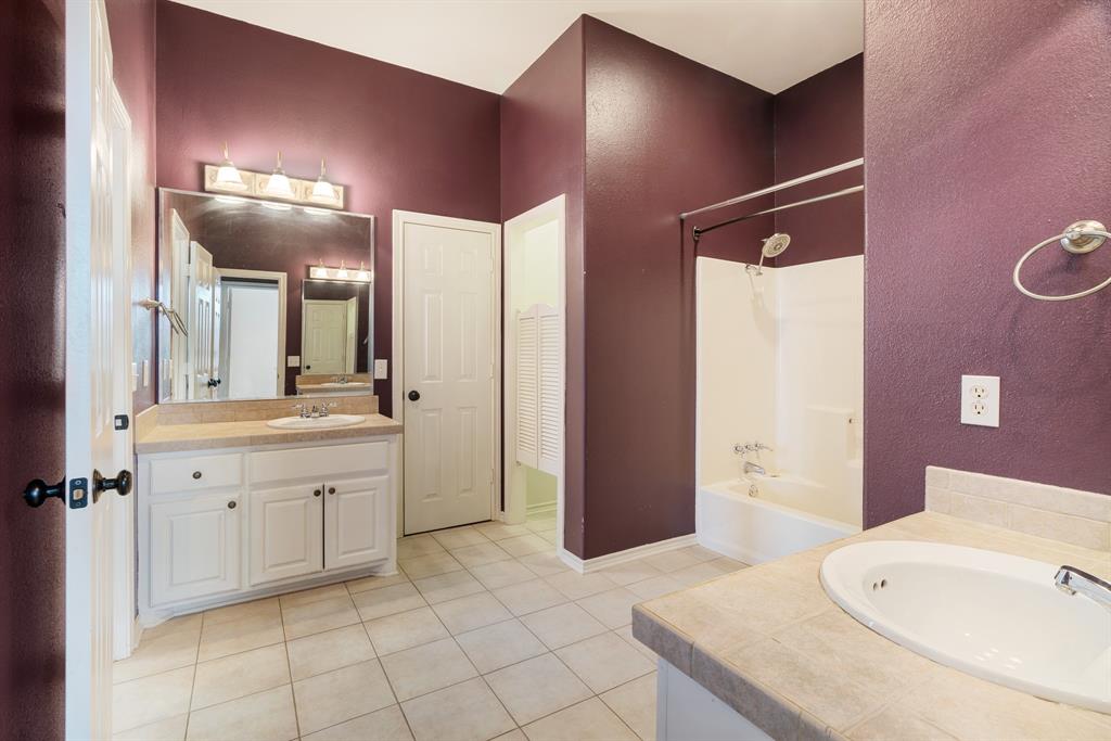 512 Brookes Way Reno, TX 75462 - Photo 24 of 27 a spacious bathroom with a sink double vanity and a mirror