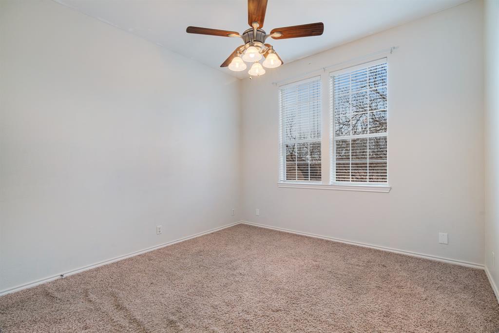 512 Brookes Way Reno, TX 75462 - Photo 25 of 27 an empty room with a window and a fan