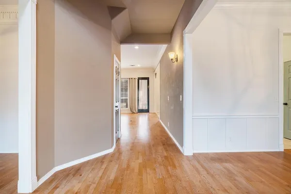 a view of a hallway with wooden floor