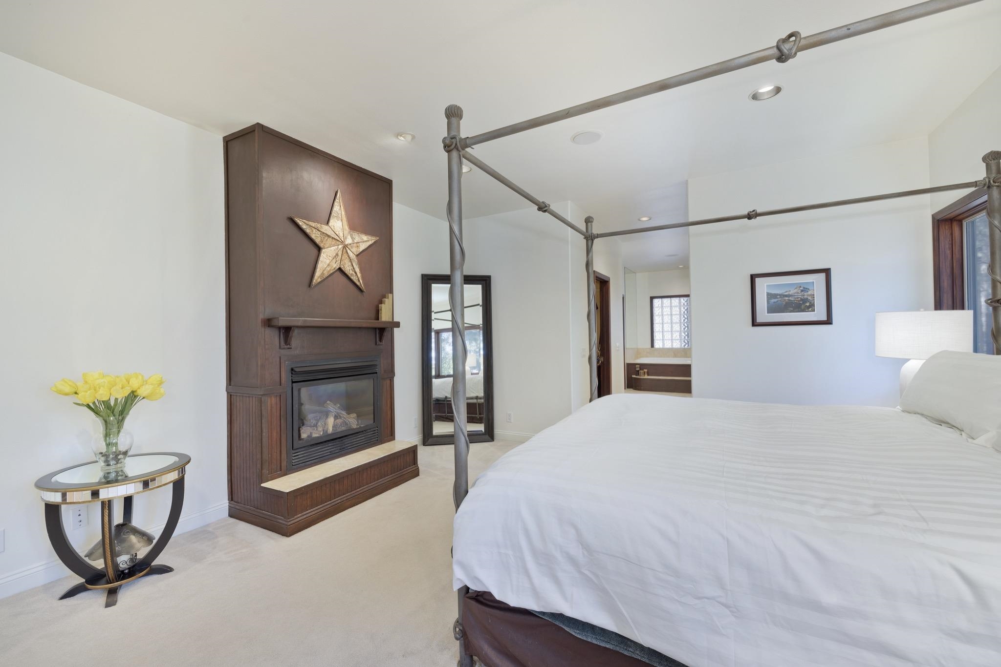 378 Ridge Way Mammoth Lakes, CA 93546 - Photo 22 of 43 Bedroom featuring a built-in fireplace with a dark wood surround and mantel