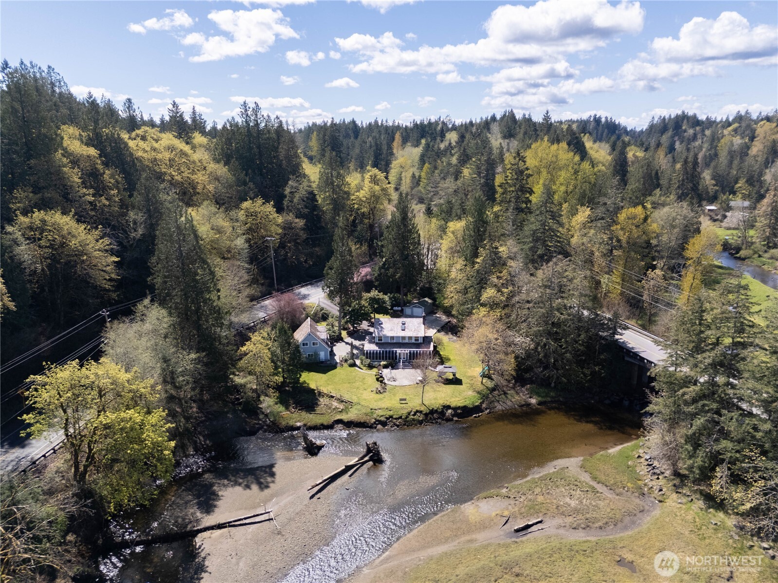 8320 East Grapeview Loop Road Allyn, WA 98524 - Photo 3 of 38 a view of a lake in front of a house