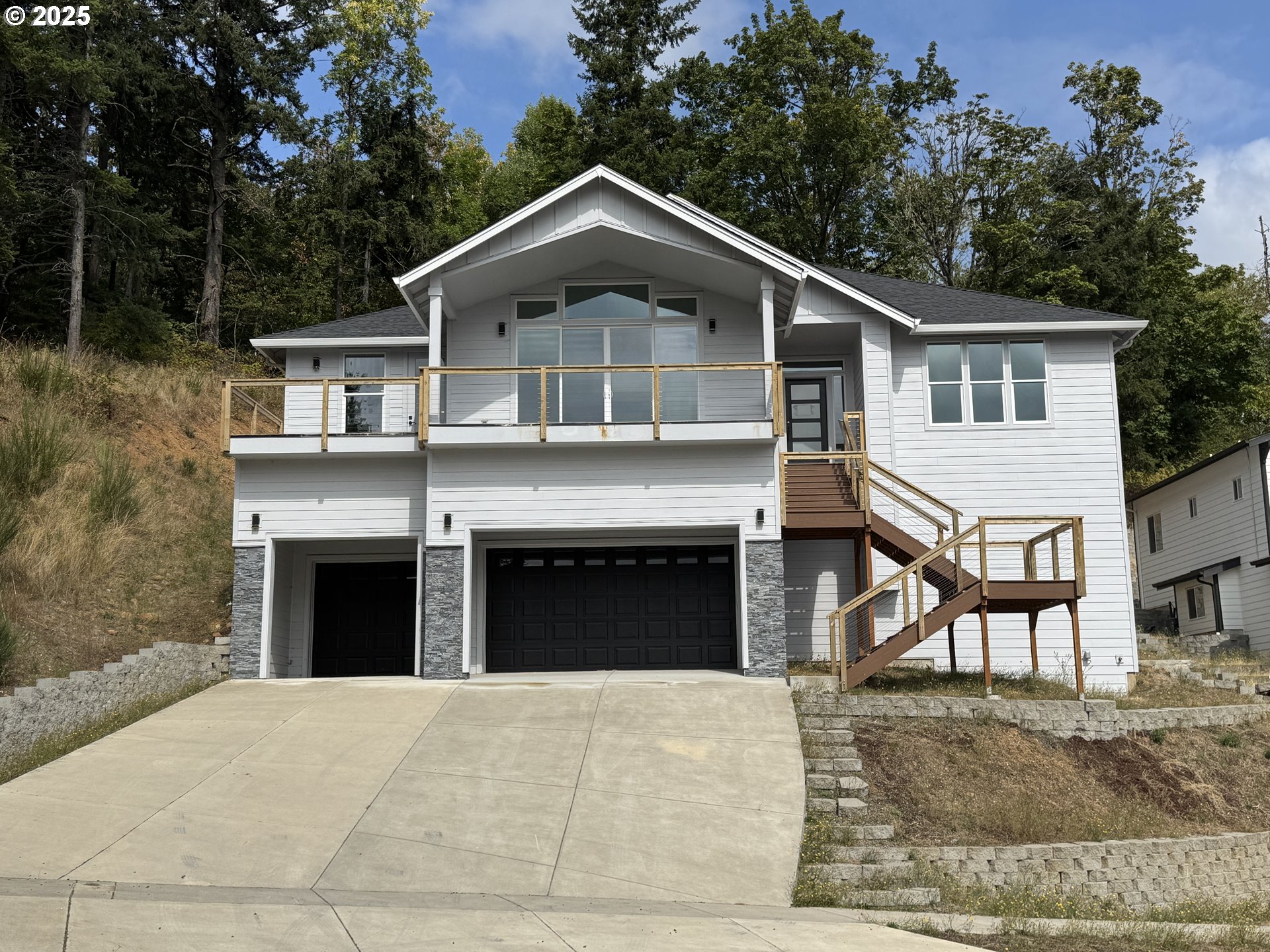 a front view of a house with yard and parking