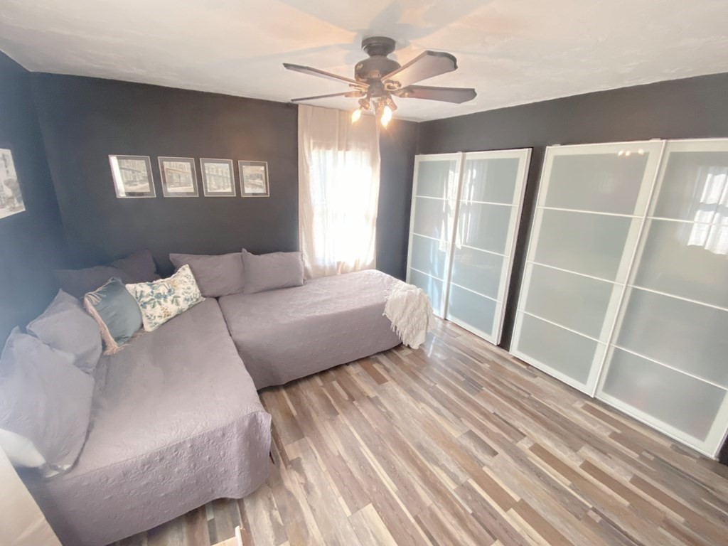 70 Uxbridge Road Mendon, MA 01756 - Photo 24 of 42 a bedroom with a large bed and a chandelier