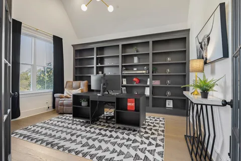 a kitchen with stainless steel appliances kitchen island a table and chairs in it