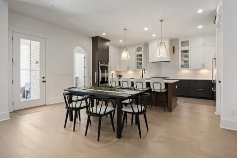 a kitchen with granite countertop a sink a counter space appliances and cabinets