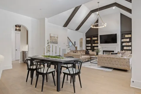 a living room with furniture chandelier and window