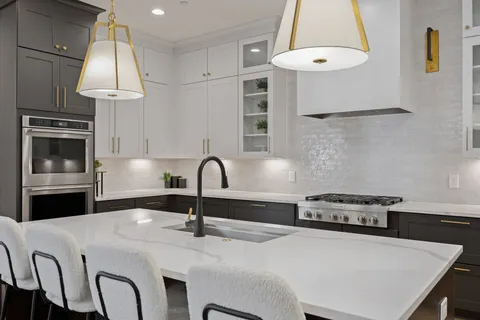 a spacious bedroom with a bed and a chandelier