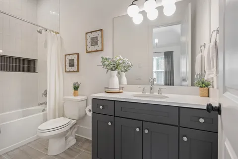 a living room with furniture a ceiling fan and a rug