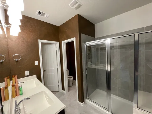 a bathroom with a shower and a sink