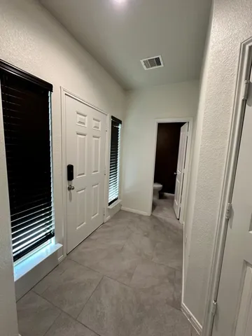 a view of a livingroom with an empty space and a hallway