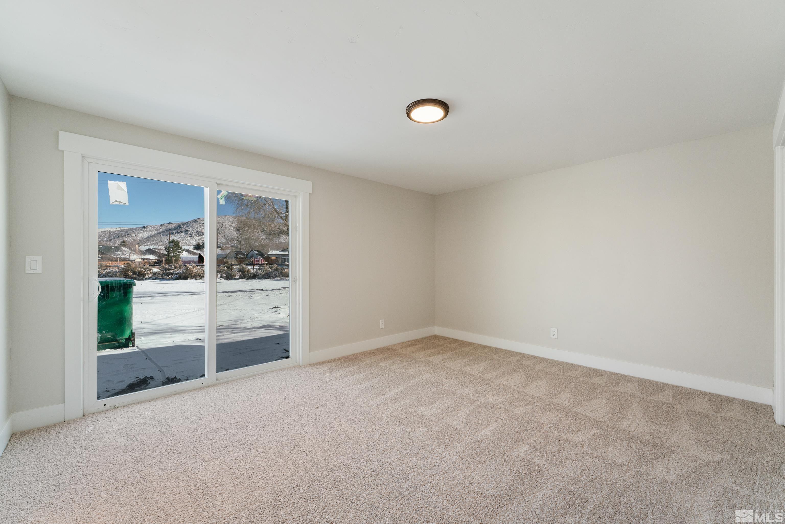 5 Sentinel Circle Carson City, NV 89701 - Photo 25 of 39 an empty room with wooden floor and windows