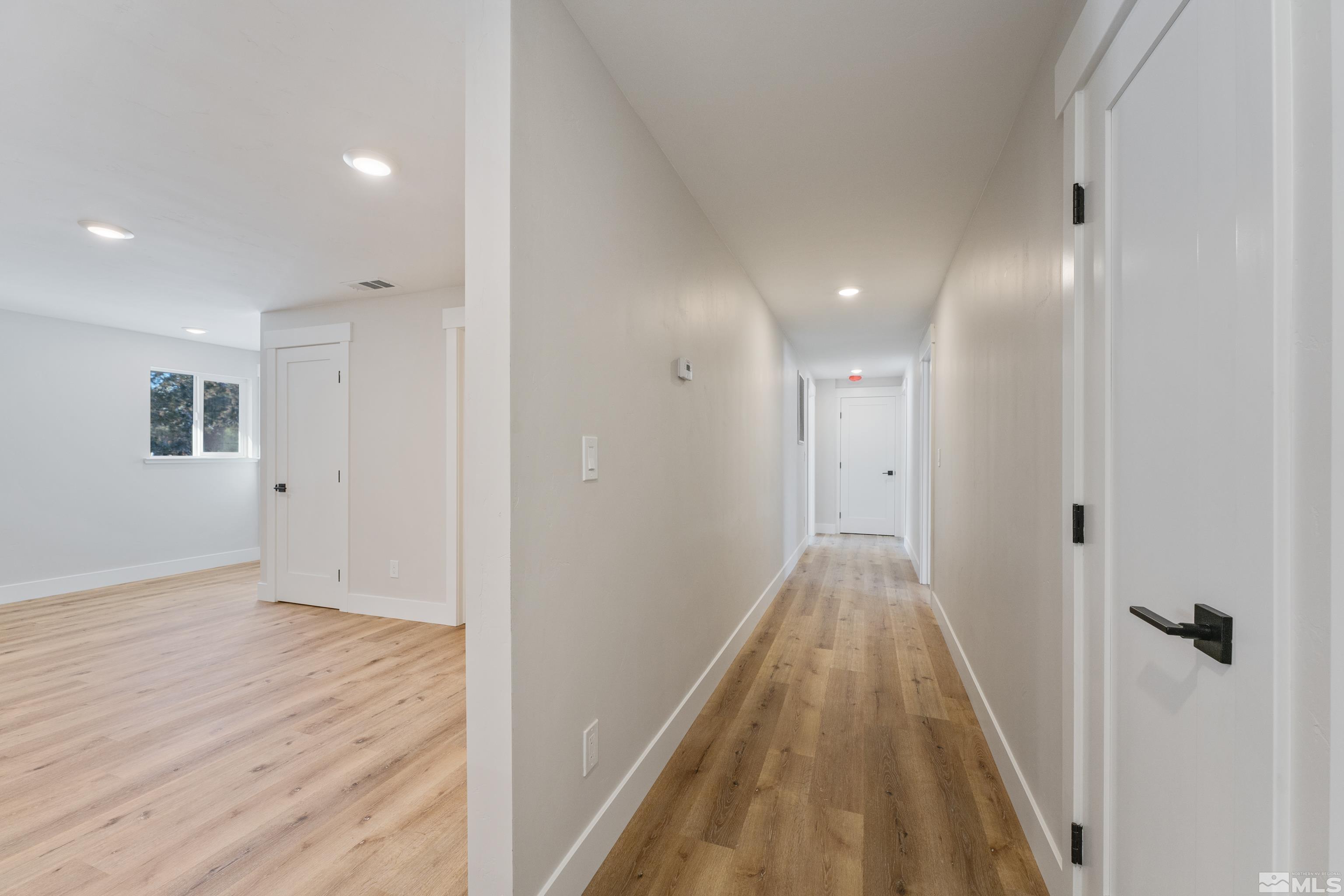 5 Sentinel Circle Carson City, NV 89701 - Photo 26 of 39 a view of a hallway with wooden floor and a bathroom