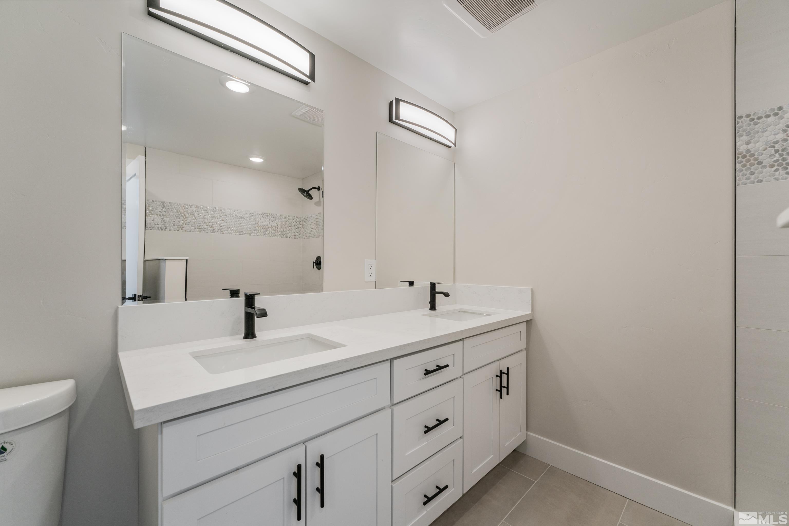5 Sentinel Circle Carson City, NV 89701 - Photo 31 of 39 a bathroom with a double vanity sink and mirror