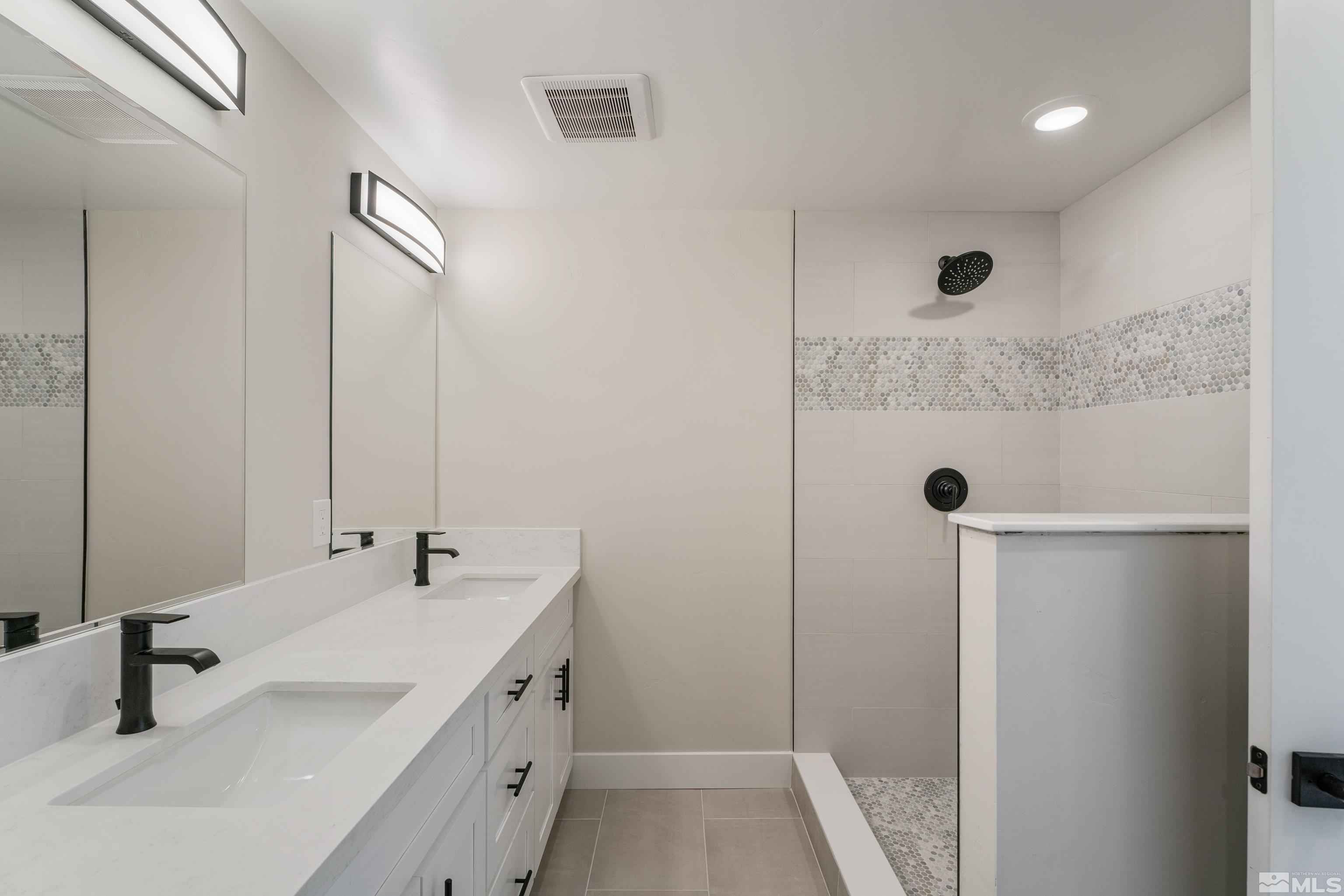 5 Sentinel Circle Carson City, NV 89701 - Photo 32 of 39 a bathroom with a double vanity sink and mirror