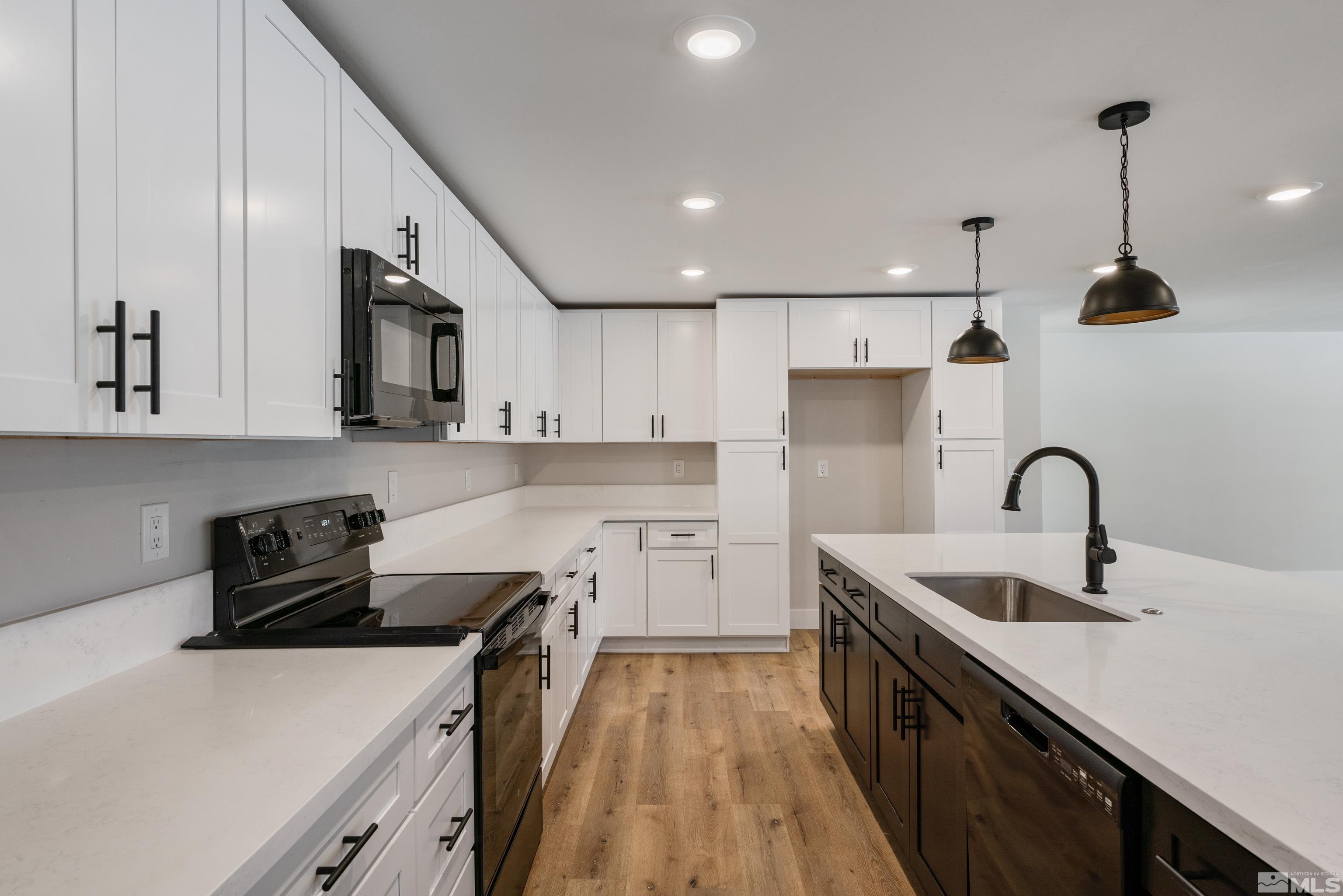 5 Sentinel Circle Carson City, NV 89701 - Photo 4 of 39 a kitchen with a sink a stove and cabinets