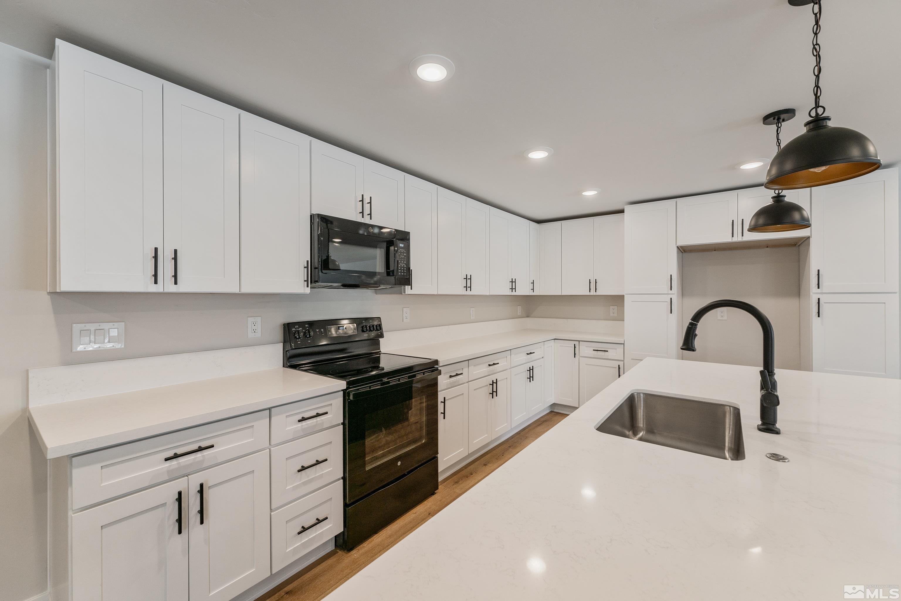 5 Sentinel Circle Carson City, NV 89701 - Photo 5 of 39 a kitchen with white cabinets stainless steel appliances and sink