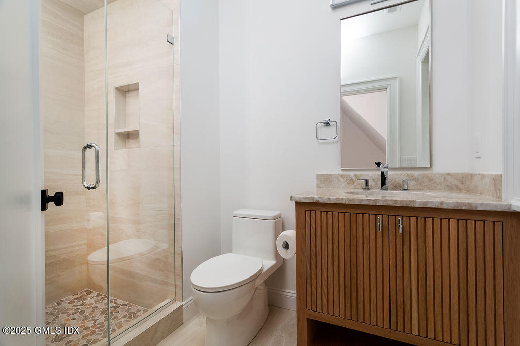 6 Dorchester Lane Riverside, CT 06878 - Photo 29 of 54 a bathroom with a sink a toilet and shower