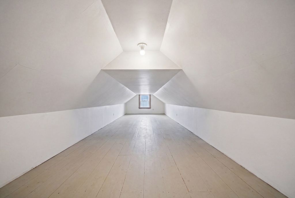 131 Range Heights Road Lynn, MA 01904 - Photo 28 of 36 a view of a hallway with a ceiling fan and wooden floor
