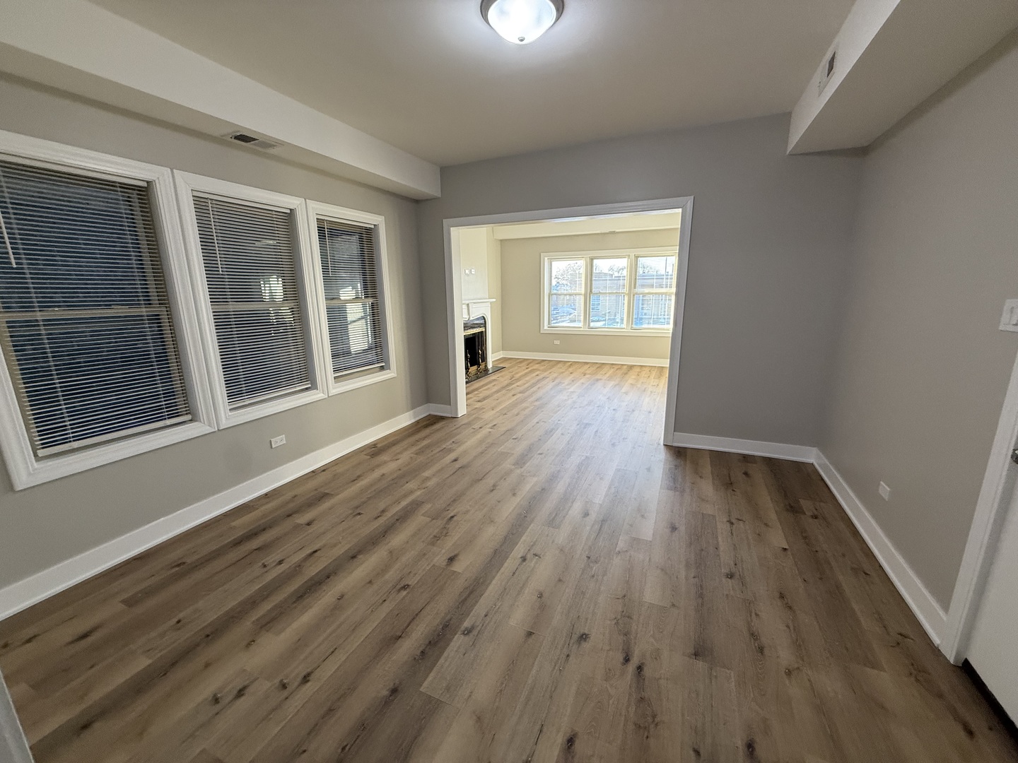 6634 Cermak Road, Unit 2 Berwyn, IL 60402 - Photo 6 of 20 a view of an empty room with wooden floor and a window