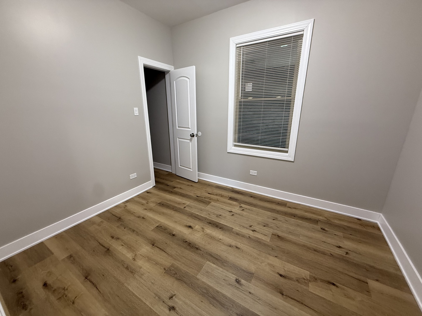 6634 Cermak Road, Unit 2 Berwyn, IL 60402 - Photo 9 of 20 a view of an empty room with wooden floor and a window