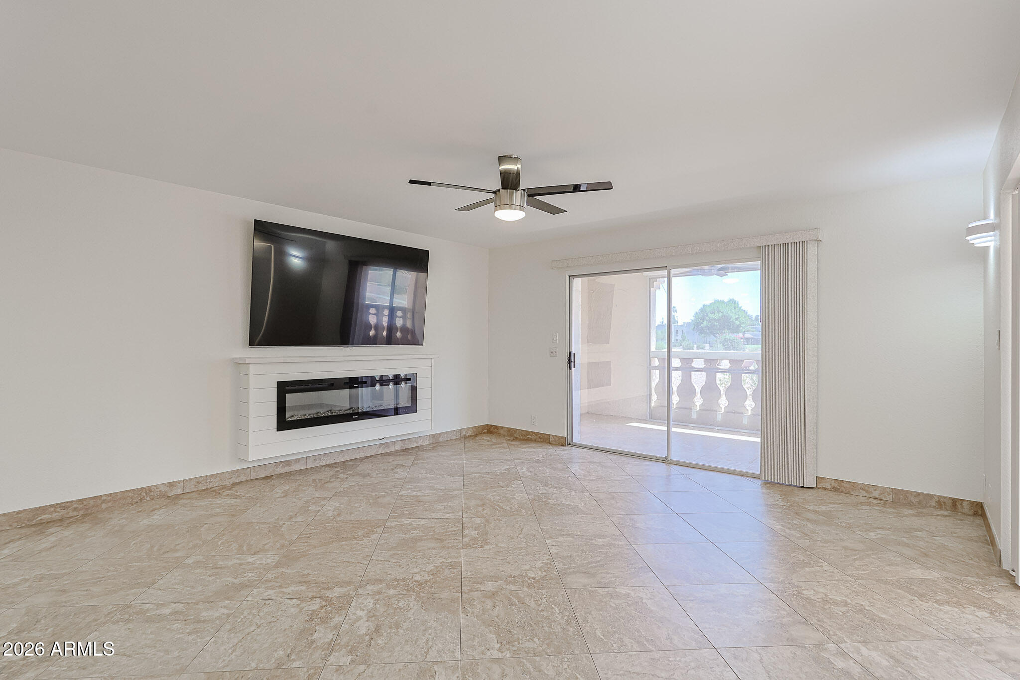 7920 East Camelback Road, Unit 111 Scottsdale, AZ 85251 - Photo 11 of 32 an empty room with windows and ceiling fan