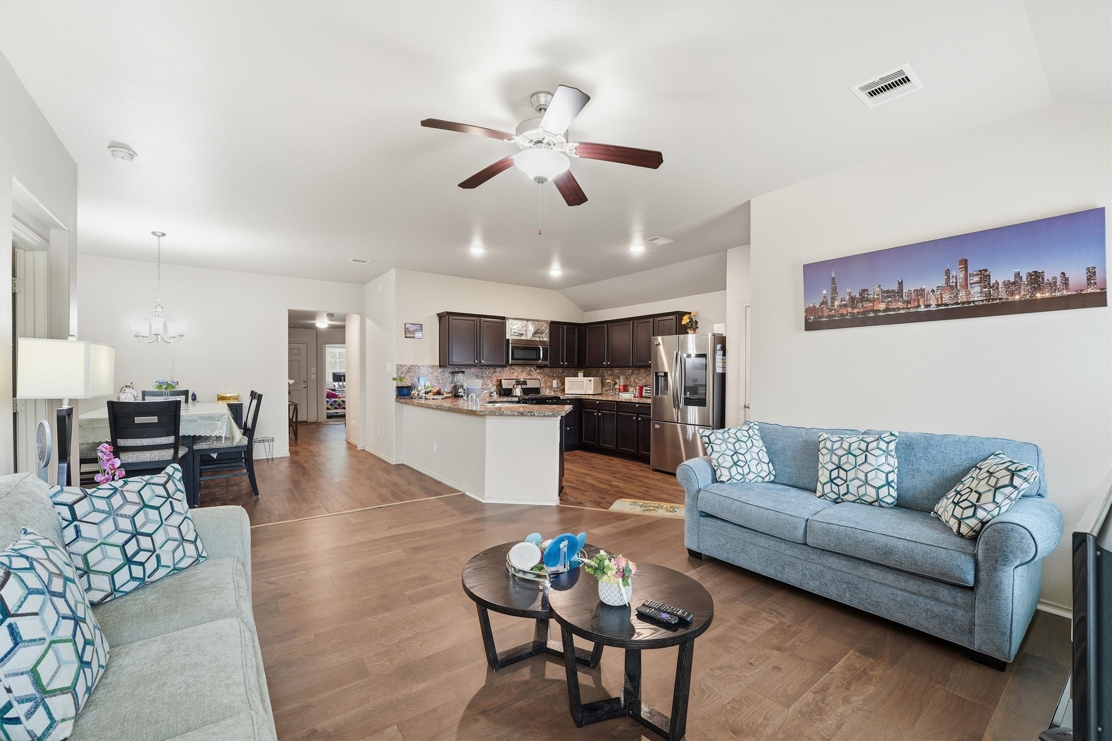 15455 Rancho Joya Way Houston, TX 77049 - Photo 10 of 20 a living room with furniture kitchen view and a chandelier