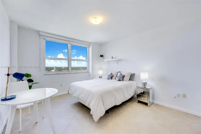 a bedroom with a bed and a table