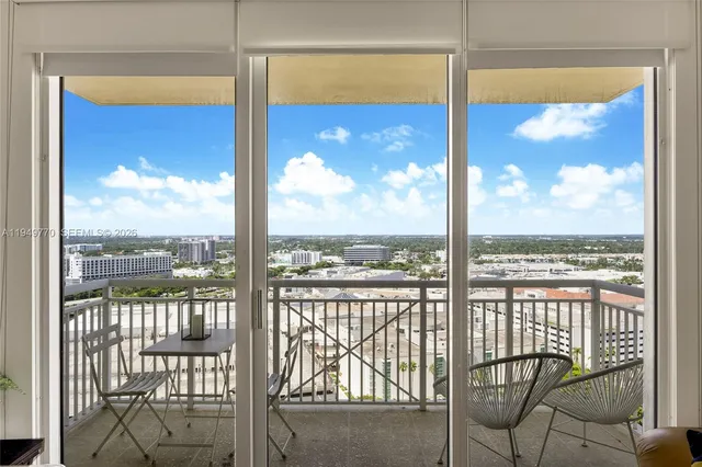 a view of a glass door with a city from a dining room
