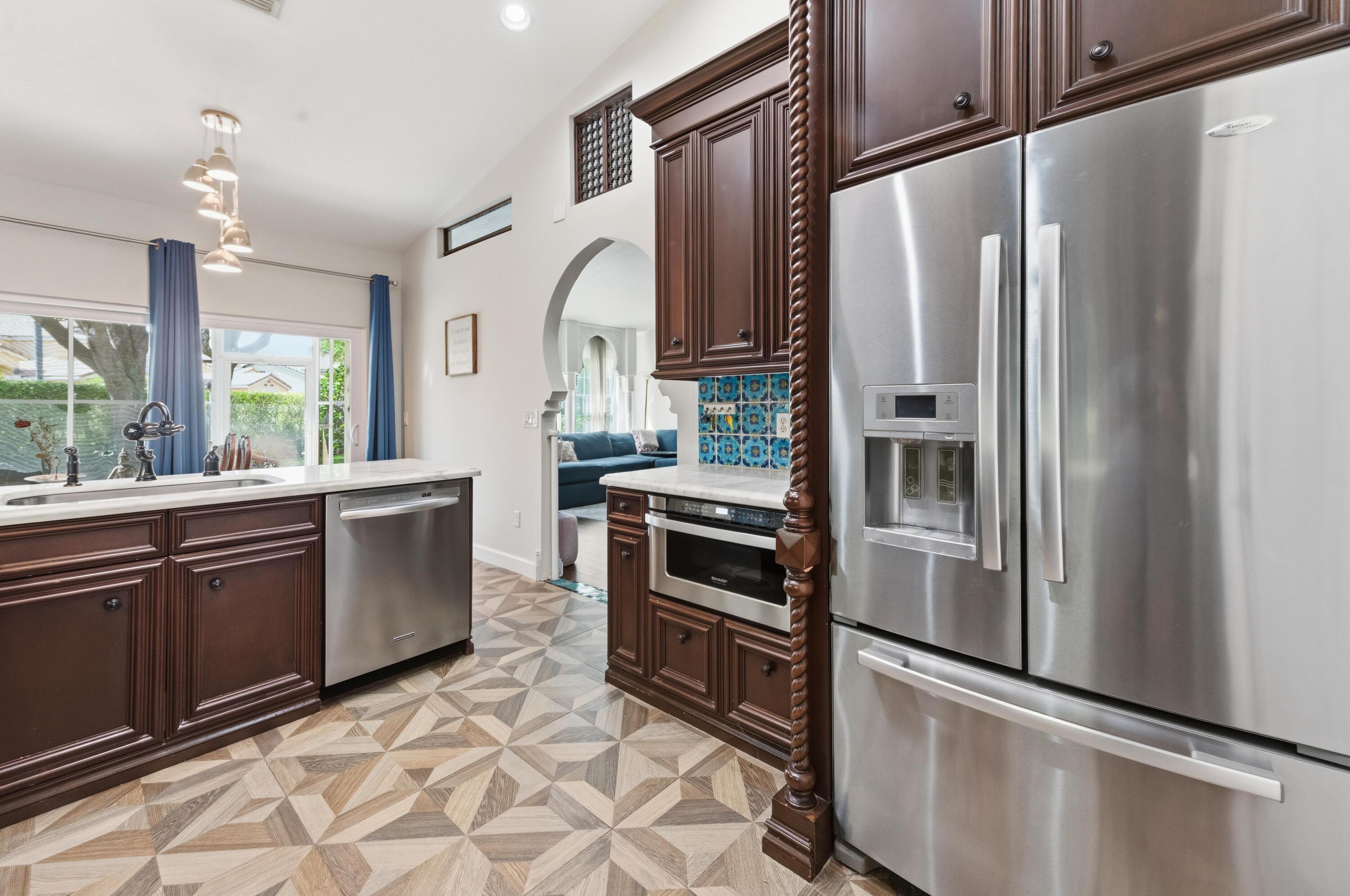 17221 Boca Club Boulevard, Unit 3 Boca Raton, FL 33487 - Photo 11 of 47 a kitchen with stainless steel appliances granite countertop a refrigerator a stove and a sink