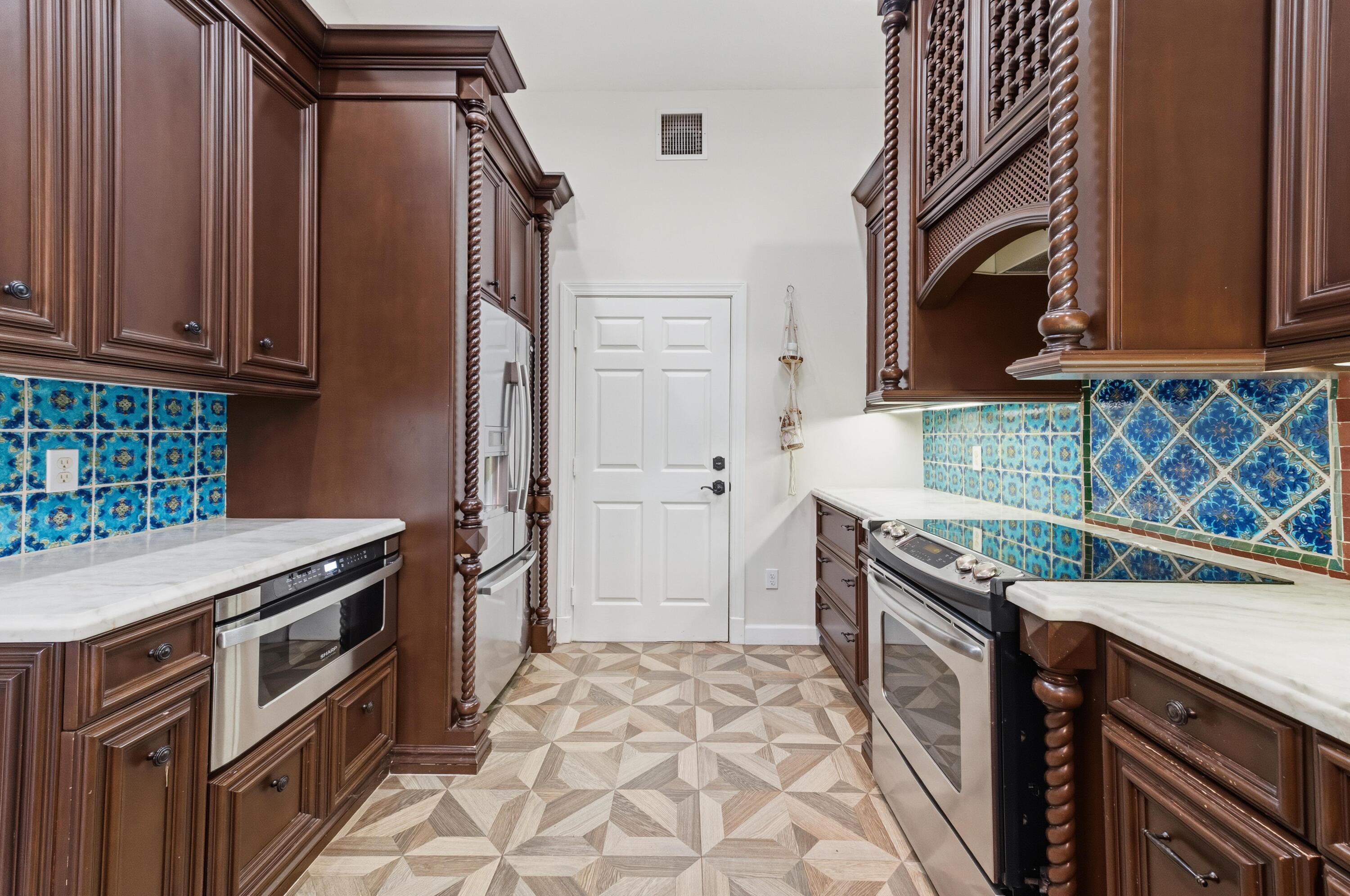 17221 Boca Club Boulevard, Unit 3 Boca Raton, FL 33487 - Photo 13 of 47 a kitchen with a stove sink and cabinets