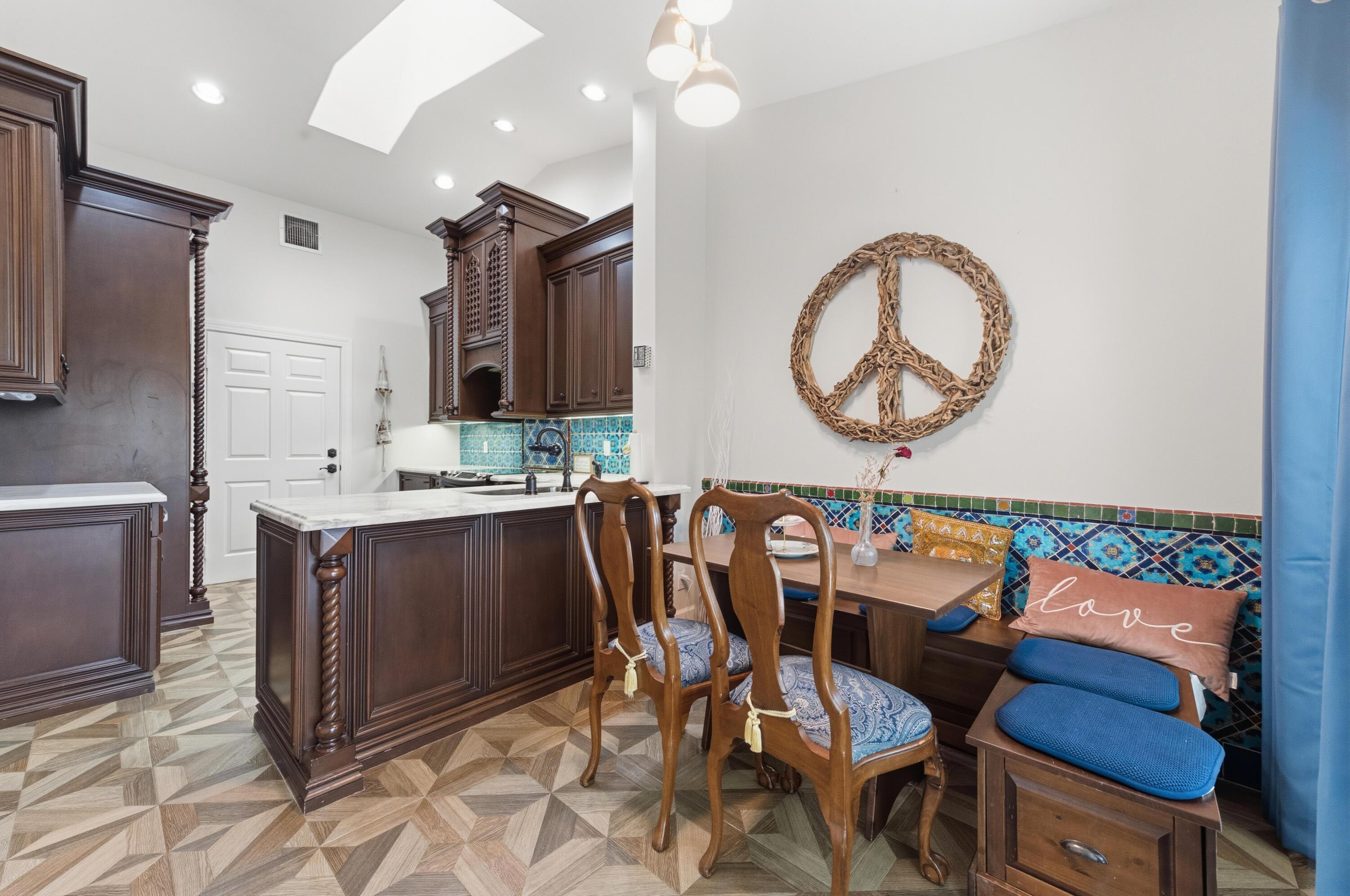 17221 Boca Club Boulevard, Unit 3 Boca Raton, FL 33487 - Photo 15 of 47 a kitchen with a table chairs sink and cabinets