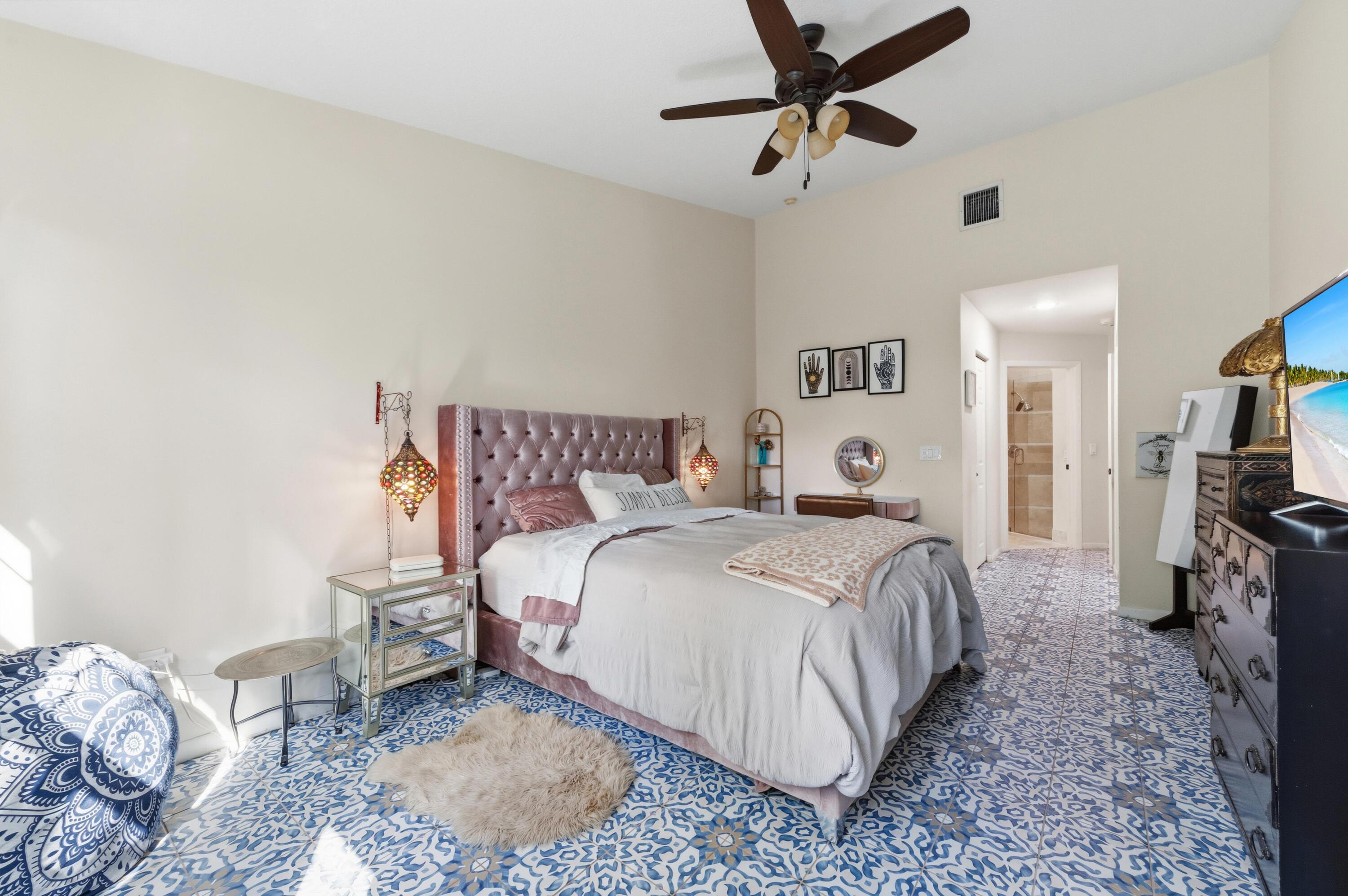 17221 Boca Club Boulevard, Unit 3 Boca Raton, FL 33487 - Photo 19 of 47 a bedroom with a bed and a chandelier