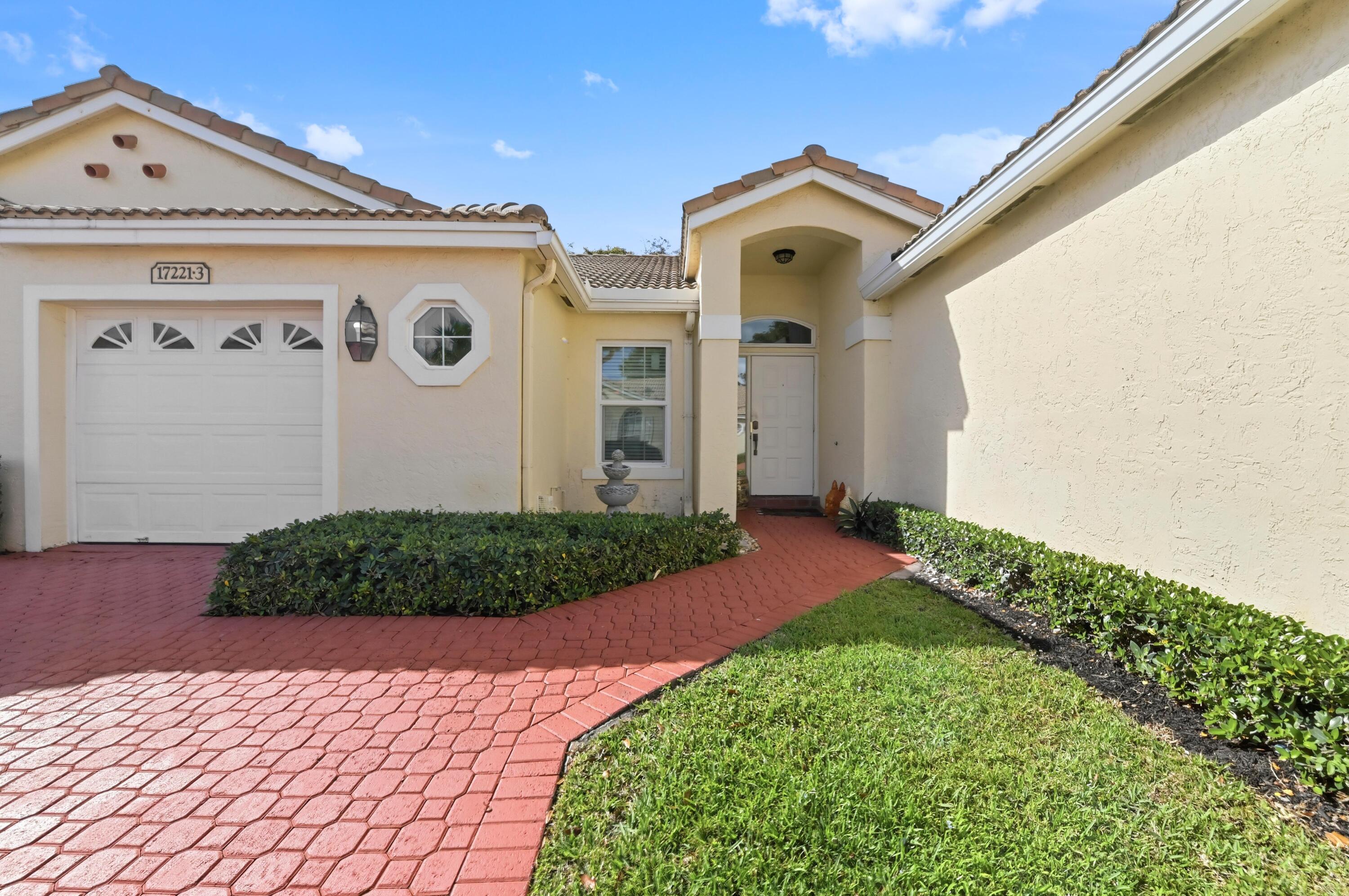 17221 Boca Club Boulevard, Unit 3 Boca Raton, FL 33487 - Photo 2 of 47 a front view of a house with garden